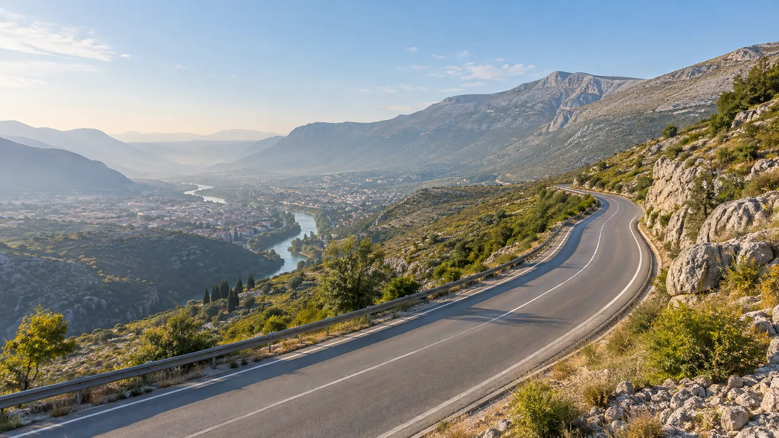 A paved road climbs from the Mostar basin toward the rocky Podveležje plateau.