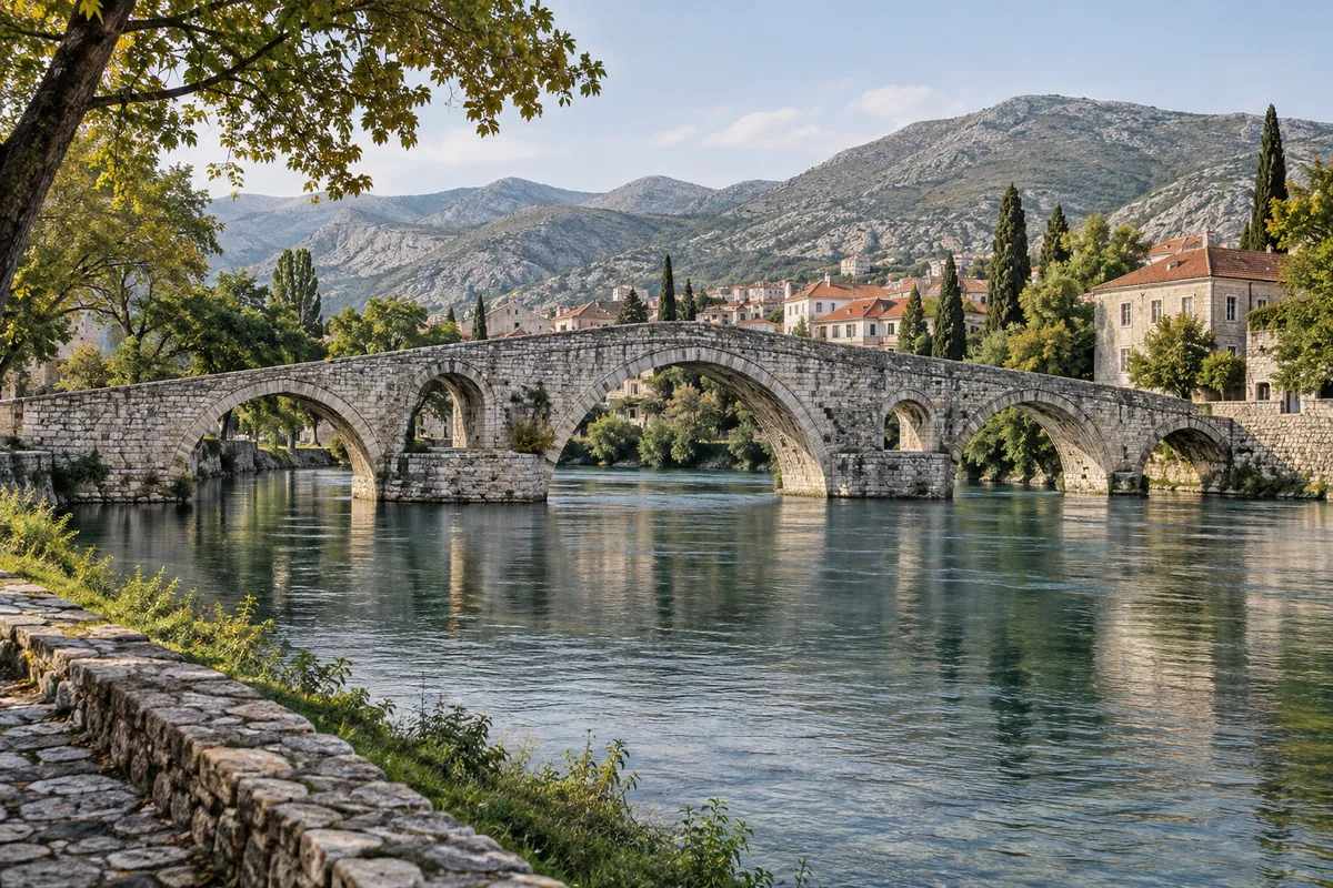 Stone arches inspired by Perović Bridge span a river near the end of the ride in Trebinje.