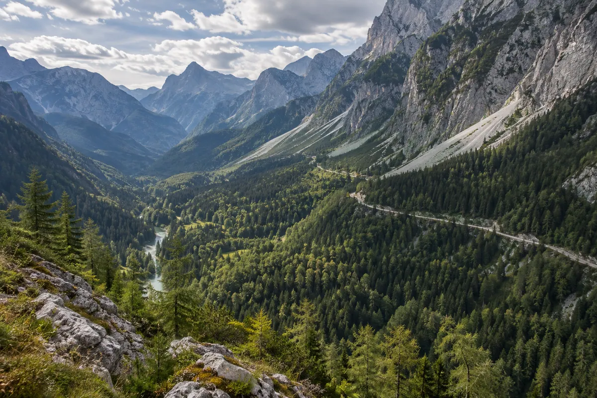 A valley road passes beneath forested limestone slopes in a Julian Alps-inspired landscape.